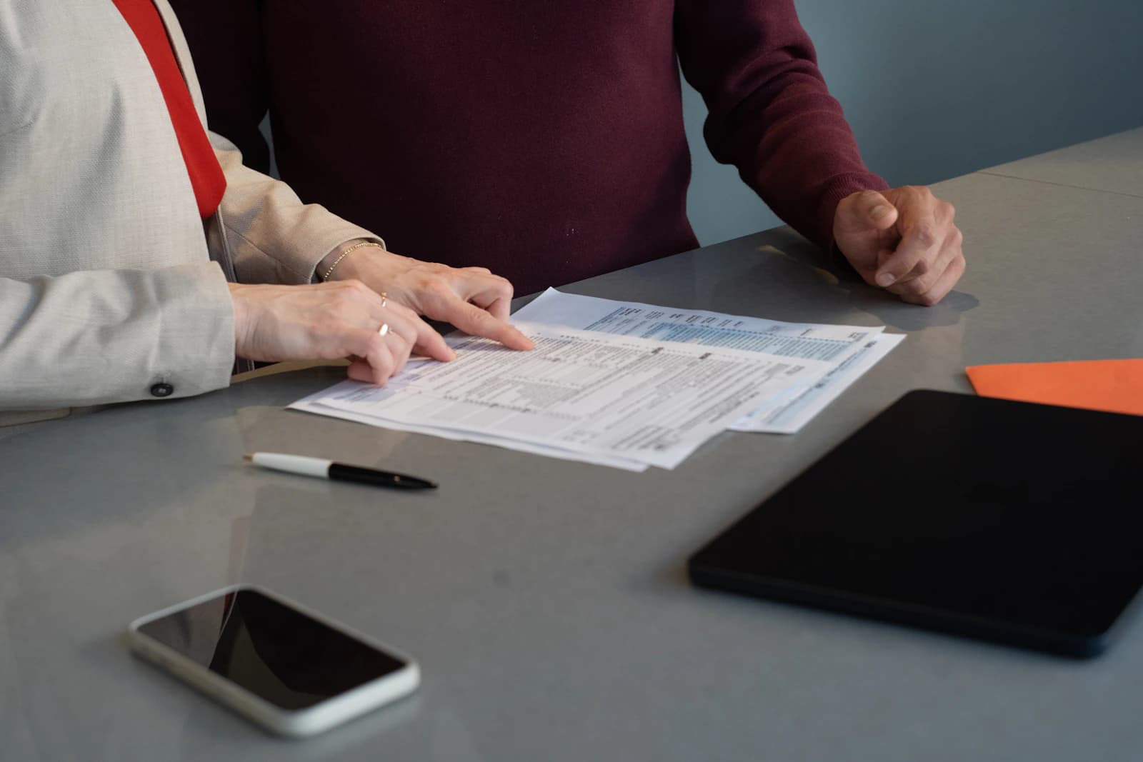 Two professionals reviewing financial documents together